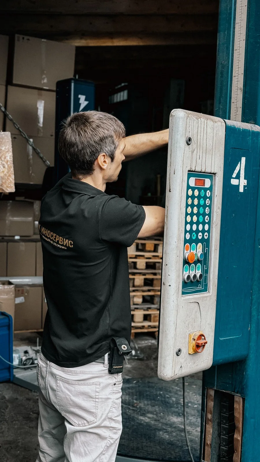 Licensed stock photograph of a warehouse worker operating a loading dock control panel